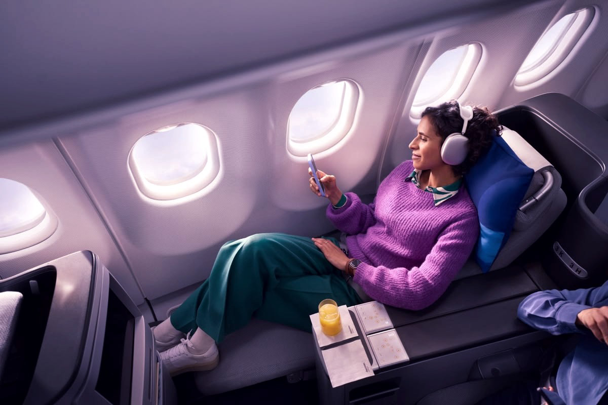 A traveller relaxing beside the window on an airplane
